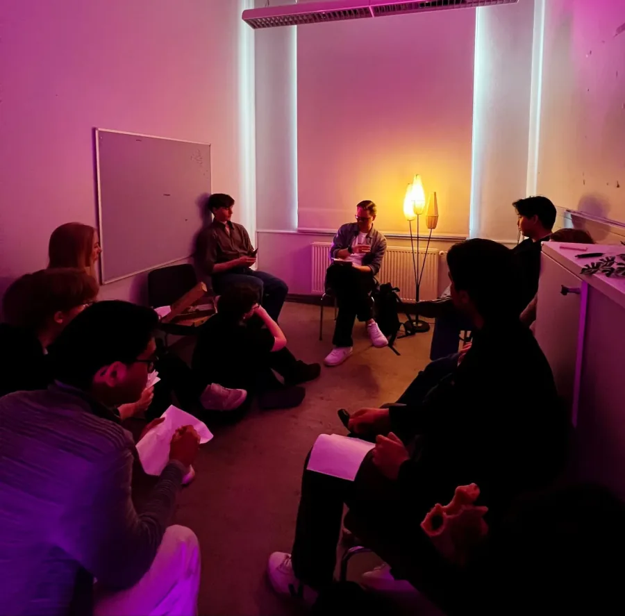 Students in a small-group roundtable discussion at a STUHI science and tech event